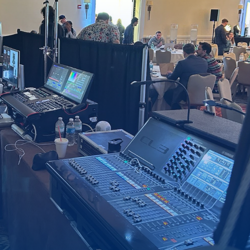 Experienced AV technician setting up audio visual equipment at a corporate event