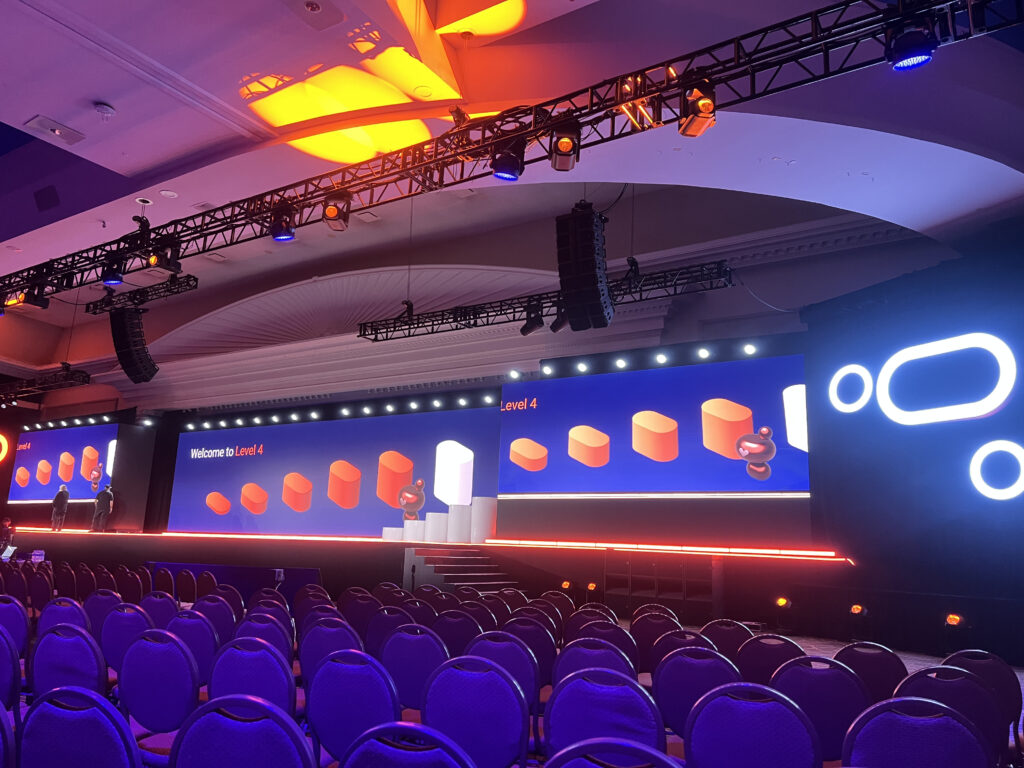 An immersive 8K LED stage setup illustrating the latest AV staffing trends 2025 for high-end corporate productions.