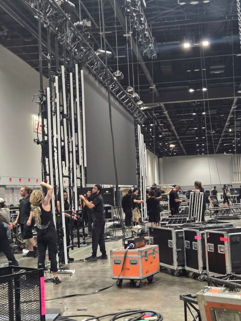 Professional event technicians from a trusted AV labor source setting up high-end production equipment.